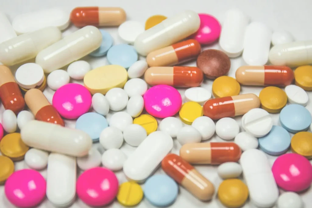 Assorted beauty supplements, including vitamins and collagen capsules, designed to enhance skin health and overall beauty.
