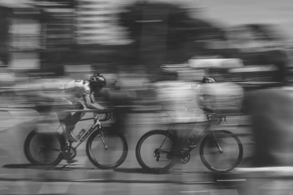 Two cyclists racing at high speed on professional road bikes – showcasing endurance, speed, and competitive sportsmanship.