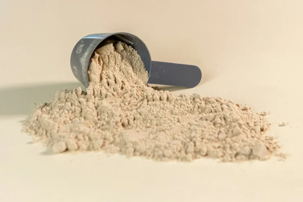 Premium protein powder in a container for muscle recovery and post-workout nutrition.