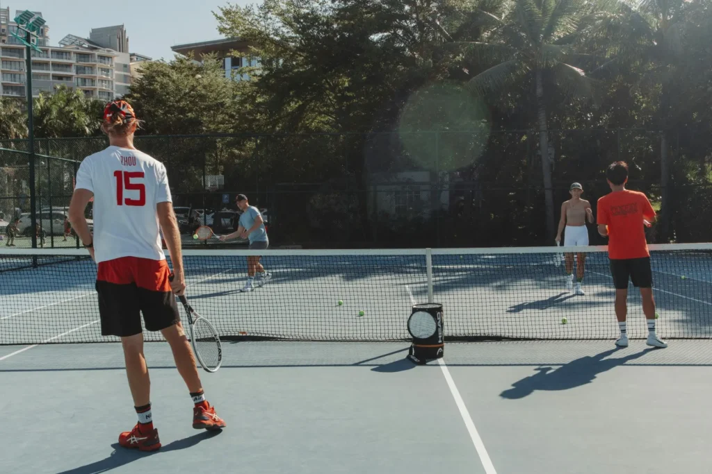 Two boys playing sports outdoors, staying active and fit while promoting a healthy lifestyle.