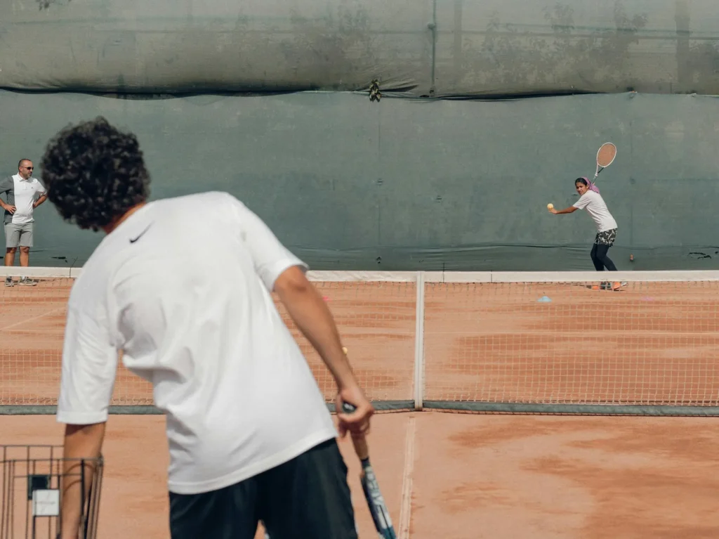 Tennis player selecting hydration supplements tailored for endurance and performance on the court.
