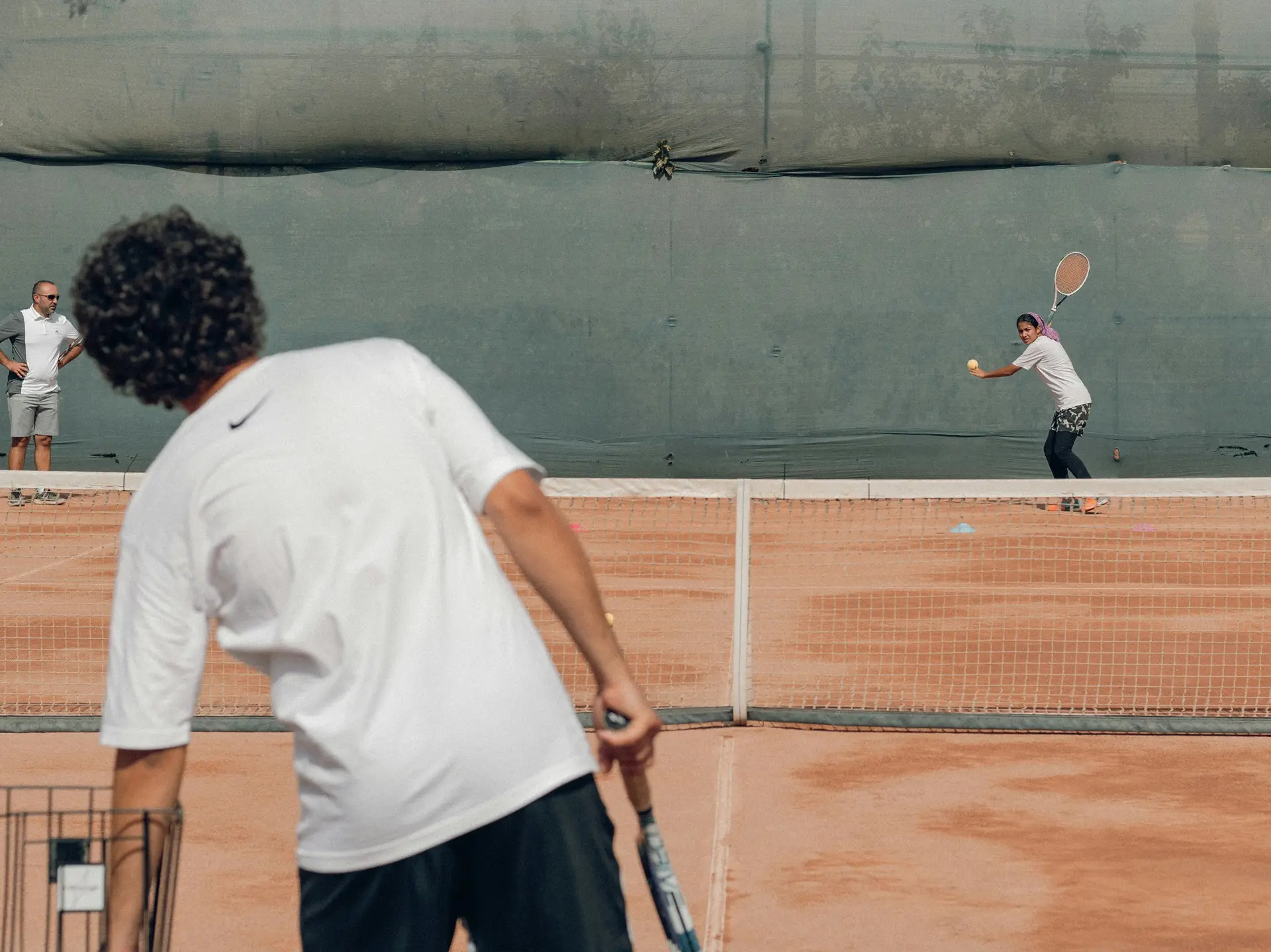 Tennis player selecting hydration supplements tailored for endurance and performance on the court.