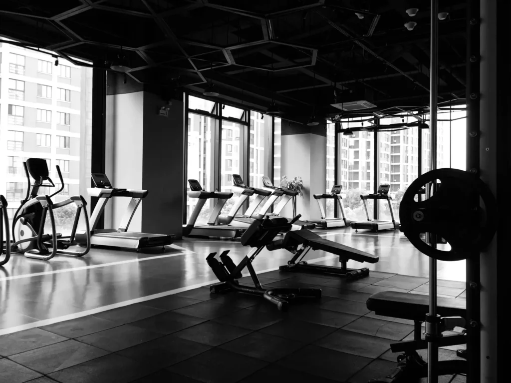 Gym-goer comparing post-workout recovery supplement packs for faster muscle repair.