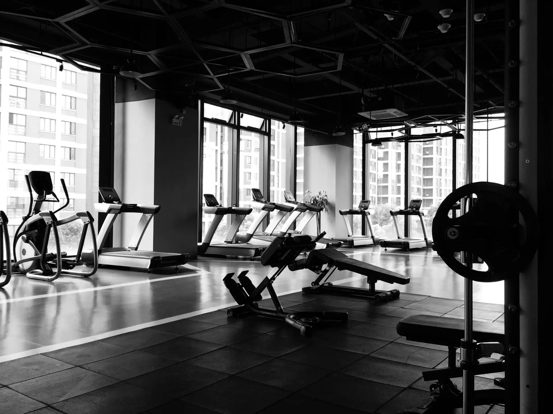 Gym-goer comparing post-workout recovery supplement packs for faster muscle repair.