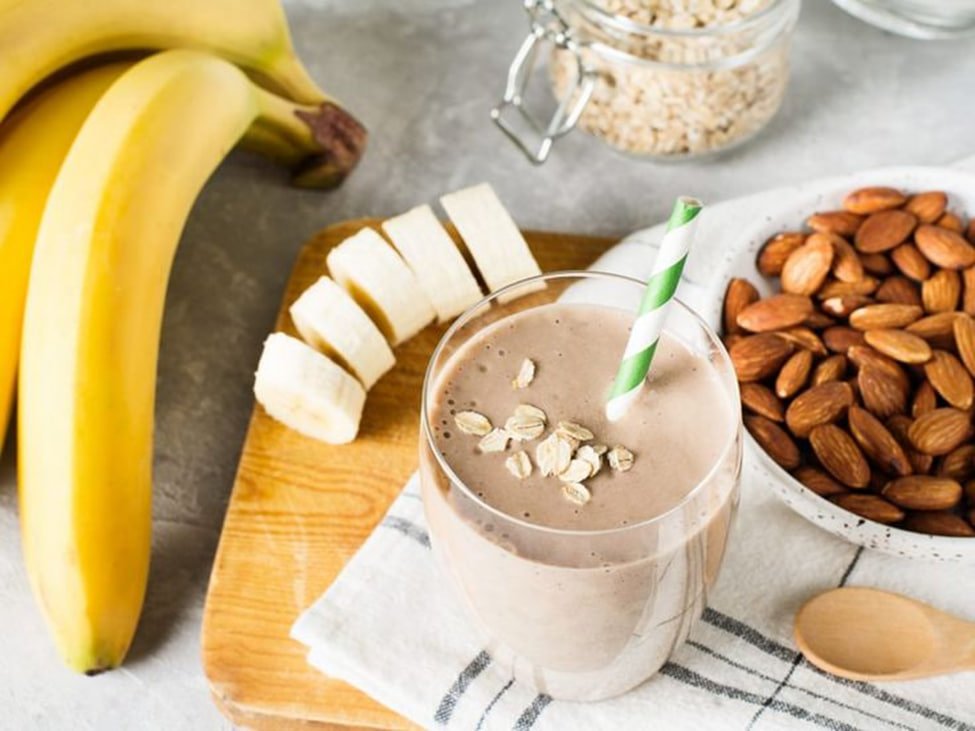 A protein smoothie with oats, almonds, pear slices and a scoop of protein powder